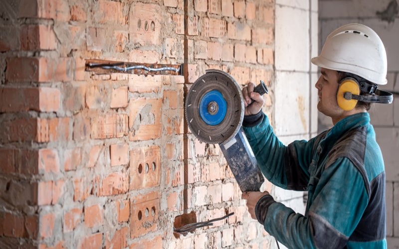 handyman-at-construction-site-works-at-grinding-bricks