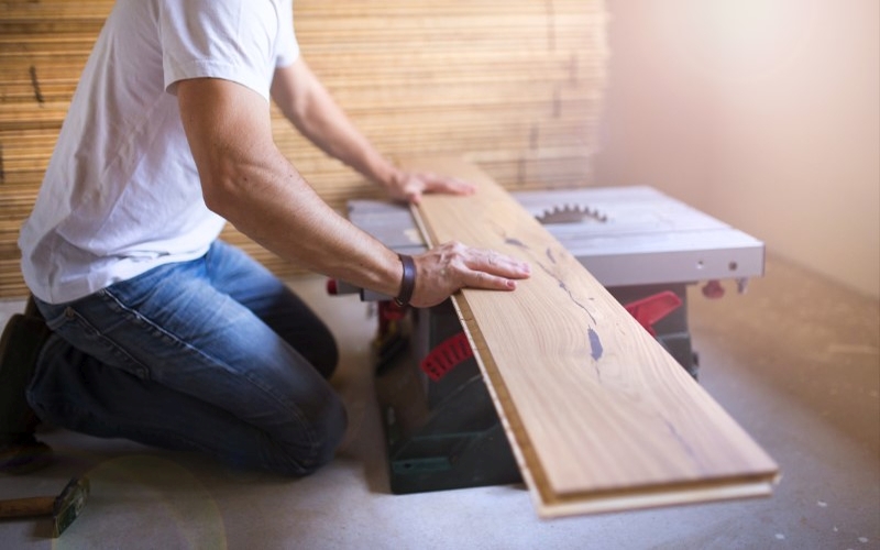 handyman-cuts-plywood-on-floor-with-circular-saw